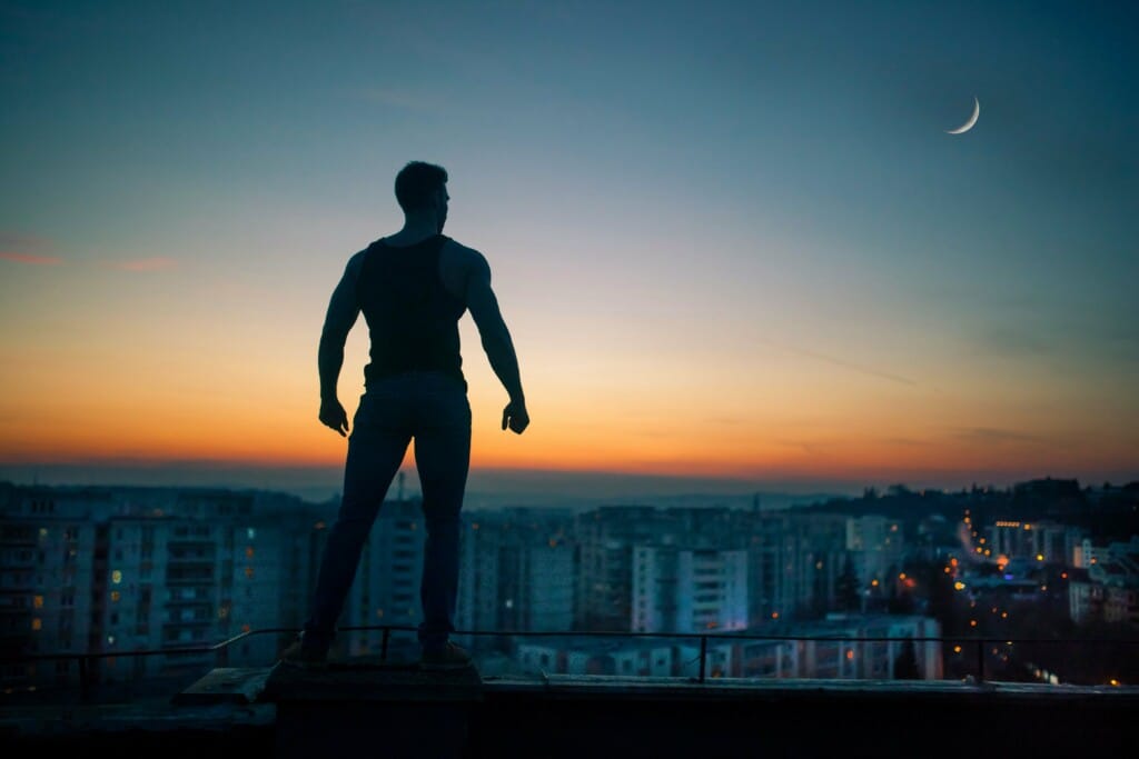 man in good physical condition on rooftop