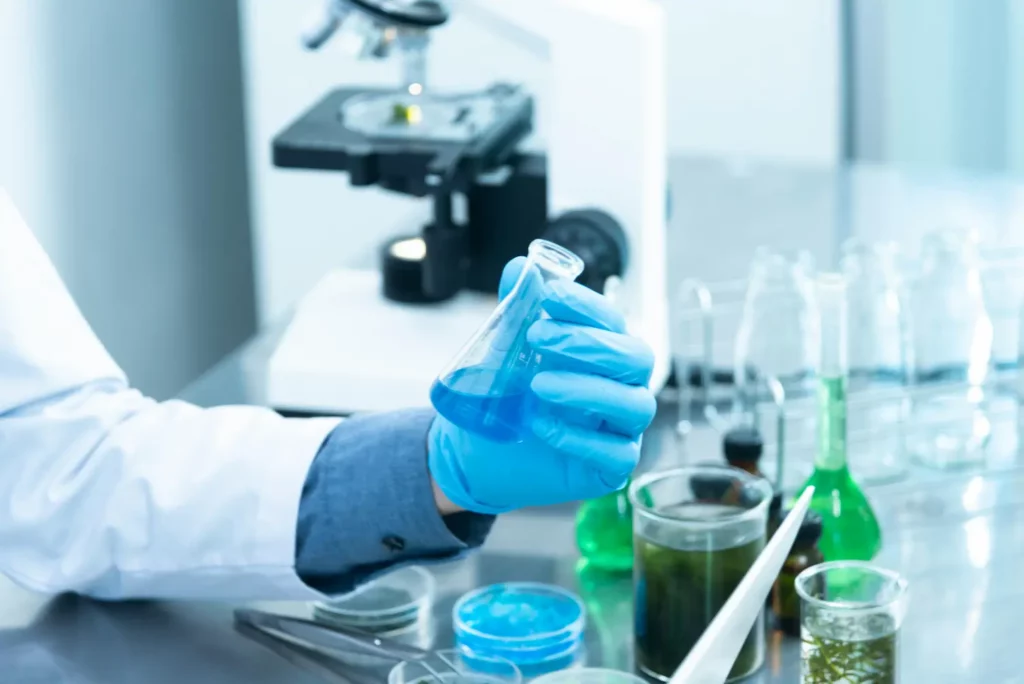 A scientist in a lab coat examines a test tube, conducting RAD 140 research in a modern laboratory environment.