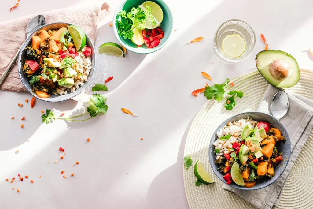 Two bowls filled with colorful vegetables and fruit sit on a table, showcasing a healthy meal option for RAD 140 Cycle.