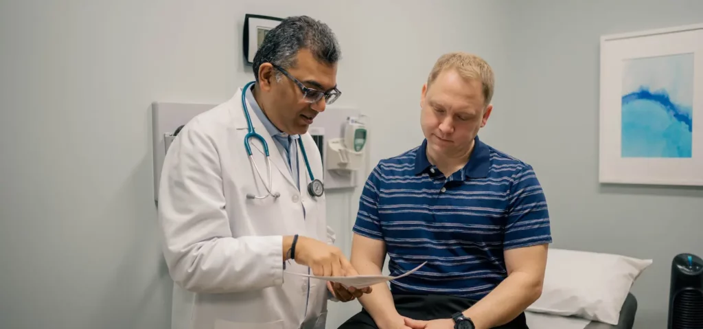 Men talking with doctor possibly about ED treatments 